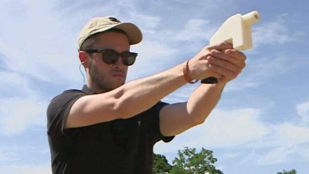 Cody Wilson holds a plastic pistol