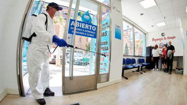 İspanya'da bir çamaşır yıkama dükkanı dezenfekte ediliyor