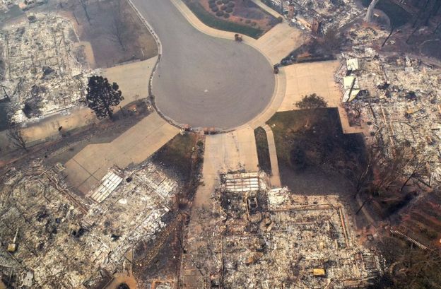 Aerial view of a road and fire-destroyed homes