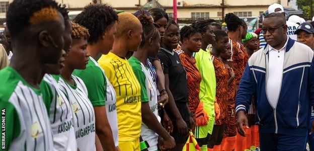 President Julius Maada Bio greets players ahead of a game
