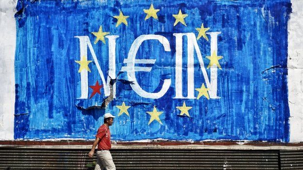 A man walks past anti-EU graffiti in Athens, Greece
