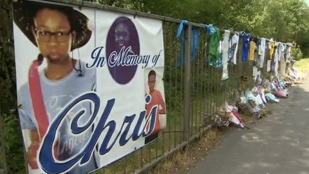 Flower tributes and banners near to where Christopher died