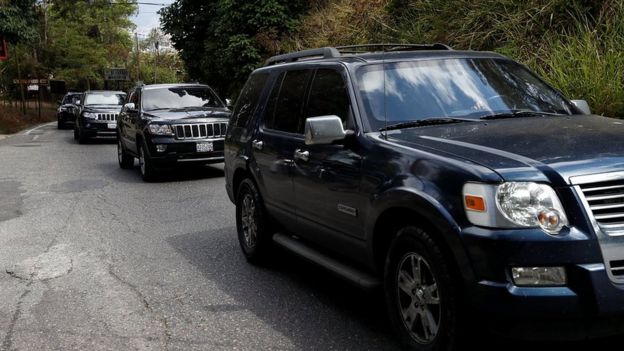 A group of vehicles are driven on the road after leaving the house of the Venezuelan opposition leader Juan Guaido in Caracas, 21 February 2019