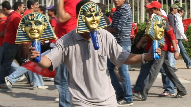 A man wearing a pharaoh mask
