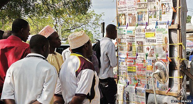 Zanzibaris scan the papers at a newsstand in Stone Town
