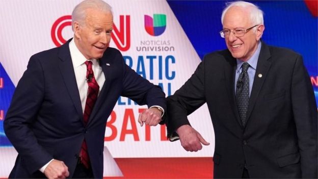 Joe Biden and Bernie Sanders elbow tap