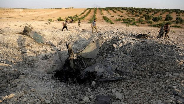 Large crater where the plane hit the ground in Idlib