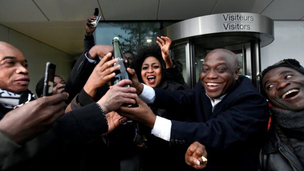 Relatives and friends of former Ivory Coast President Laurent Gbagbo celebrate outside the International Criminal Court