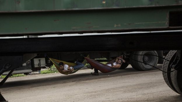 Conductores de tráiler descansan mientras esperan que les dejen pasar en el tranque de La Trinidad.