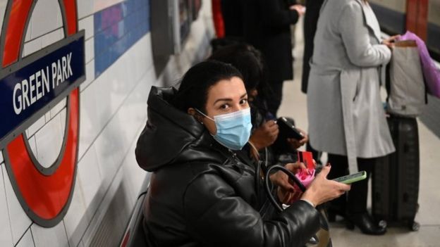 A woman wears a mask on the Tube in central London