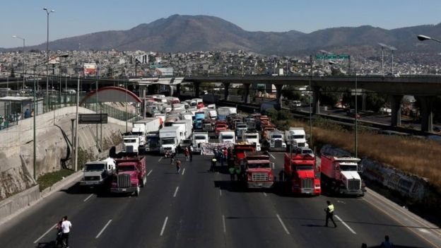 Truck drivers block the motorway known as the Mexico-Queretaro motorway, one of the principle access roads to the city, as part of a protest against the rising prices of gasoline enforced by the Mexican government in Cuatitlan Izcalli, Mexico January 4, 2017.