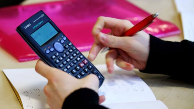 Estudiante sujetando una calculadora