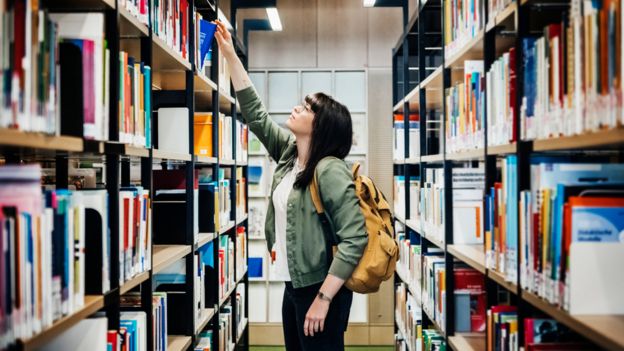 student in library