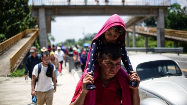 TOPSHOT - Central American migrants heading in caravan to the US rest beside the road between Metapa and Tapachula in Mexico on April 12, 2019