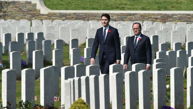 Francois Hollande and Justin Trudeau walk in the Canadian WW1 military cemetery in Vimy