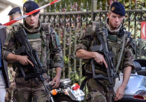 Military officers set up a security perimeter near the site where six soldiers of the anti-terrorism Sentinelle operation were hit by a car in Levallois-Perret, near Paris, on 9 August 2017.