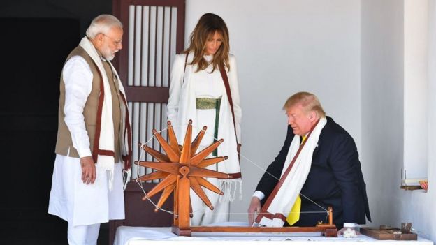 US President Donald Trump (R) and First Lady Melania Trump (C) are accompanied by India's Prime Minister Narendra Modi as they visit the Gandhi Ashram in Ahmedabad on February 24, 2020.