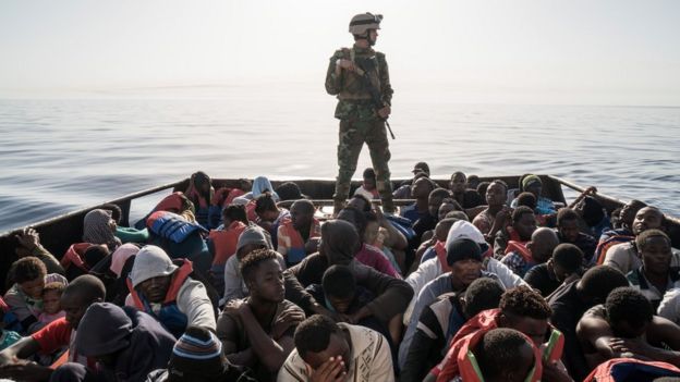 A Libyan coast guardsman stands on a boat during the pick-up of 147 illegal immigrants attempting to reach Europe off the coastal town of Zawiyah, 45 kilometres west of the capital Tripoli, on 27 June 2017