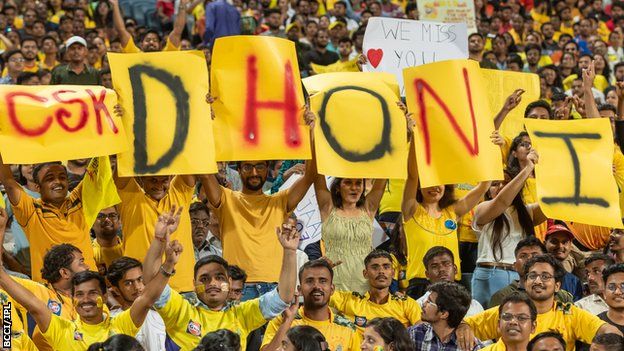 Chennai Super Kings fans hold up signs spelling out MS Dhoni's name