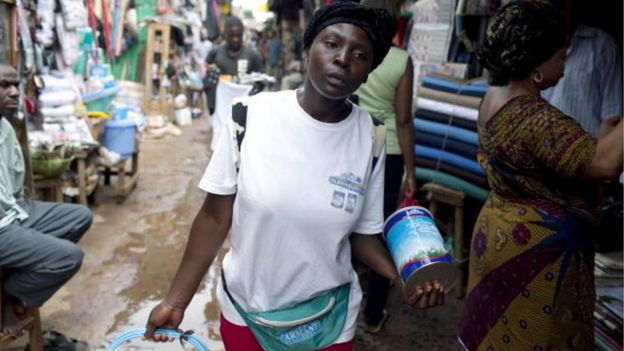 Felicity, age 20, walks in the central market selling the Oldenberger milk powder on August 8, 2009 in Bamenda, Cameroon