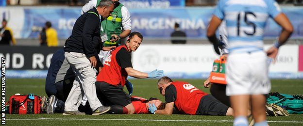 Aneurin Owen receiving treatment for a head injury in the match against Argentina