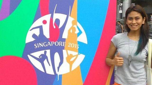Alma Cabasal poses next to a billboard in Singapore