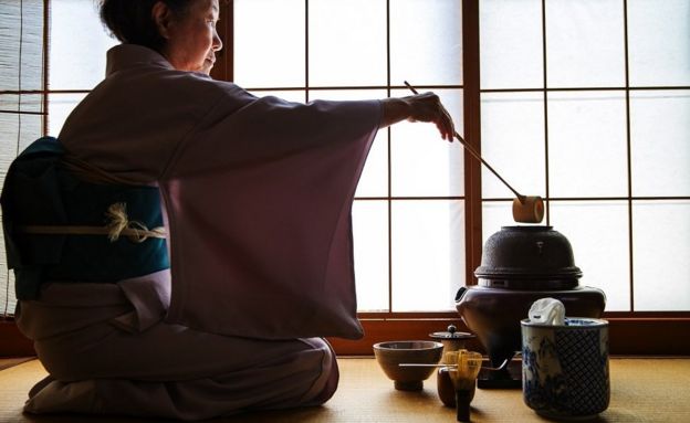 A woman performing the traditional Japanese tea ceremony