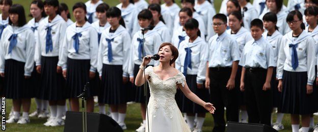 Japanese singer Ayaka Hirahara performs with Kamaishi-East junior high school students during the opening ceremony of the Kamaishi Recovery Memorial stadium