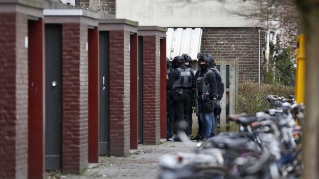 Special task forces of the Dutch police surrounds a building in their search for the attacker
