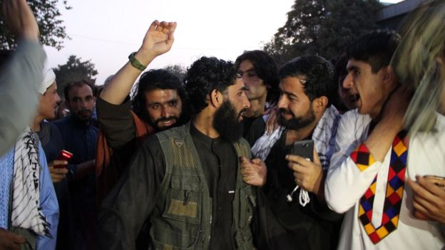 Taliban members speak to residents in Kunduz