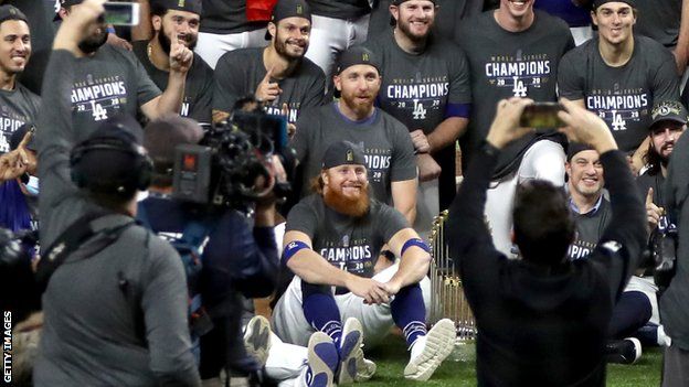 The LA Dodgers posing for a team photo after winning the World Series