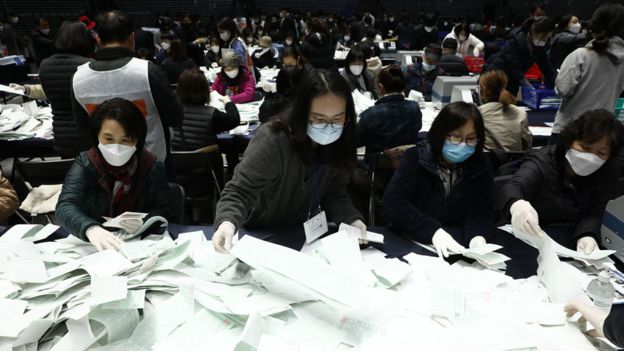 Officials from the South Korean Central Election Management Committee and election observers count votes