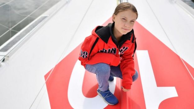 Greta Thunberg, 16-year-old climate-change activist, crouched on the yacht on which she is travelling to the US