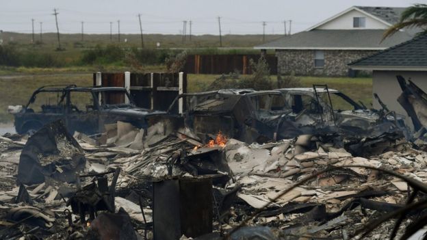 A burnt out house and cars that caught fire are seen after Hurricane Harvey hit Corpus Christi, Texas on August 26, 2017