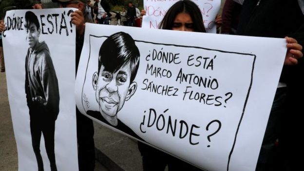 Demonstrators hold up posters with images of high school student Marco Antonio Sanchez who disappeared several days ago. Jan 28 2018