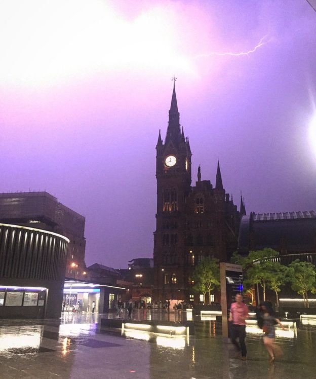 @pamelsaurusrex of lightning over King's Cross in London as two people run to escape the rain