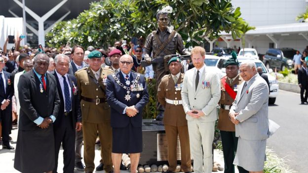 Britain"s Prince Harry and Fiji"s President Jioji Konrote pose in front of a new statue commemorating Sergeant Talaiasi Labalaba