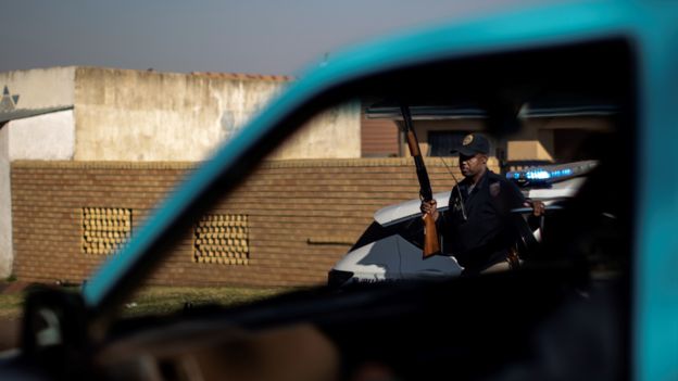 A police officer carrying a rifle in Soweto, in Johannesburg.