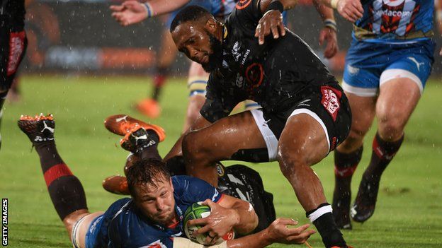 Sharks player Grant Williams tackles Bulls' Arno Botha in a Super Rugby contest last October