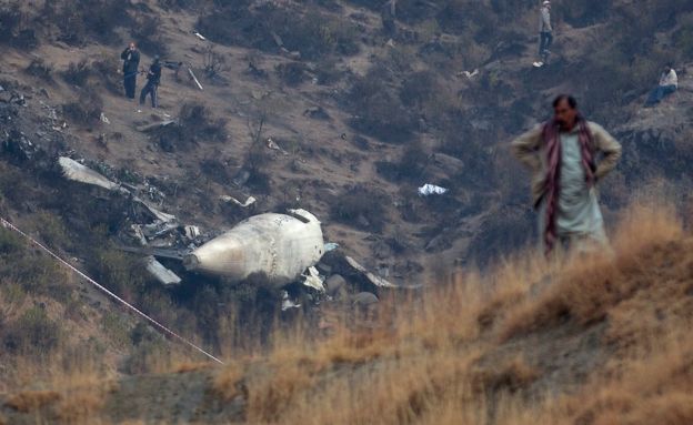 A villager stands at a site overlooking the site of plane crash, in Gugh, near Havelian, Pakistan, 8 December 2016.