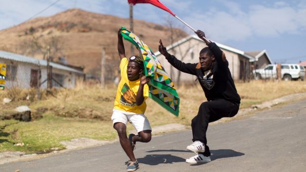 African National Congress ( ANC) and South African Communist Party ( SACP) supporters dance and sing in celebration at Wembezi township near Estcourt some 215 kilometres west of Durban on August 3, 2016.
