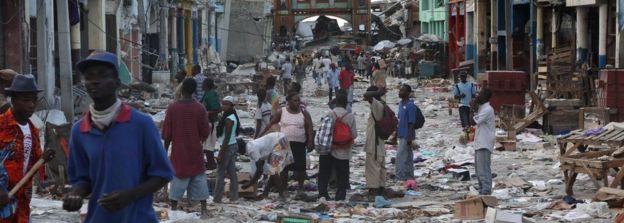 People walk in the street January 14, 2010 in Port-au-Prince.