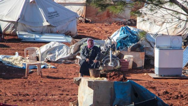 A displaced Syrian man sits in a camp near the Bab al-Hawa border crossing with Turkey. Photo: 9 February 2020