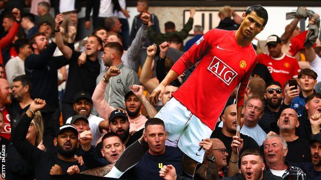 Man Utd fans hold Cristiano Ronaldo cardboard cut out at Wolves