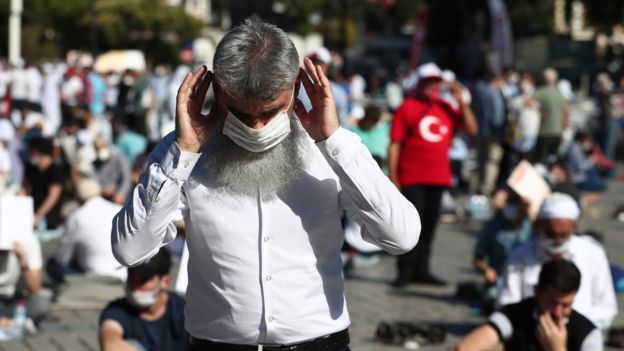 People wait for the first Friday prayer during the official opening ceremony of Hagia Sophia as a mosque in Istanbul