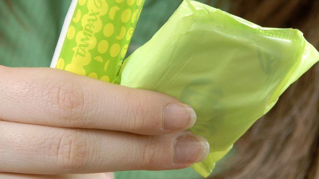 Woman with tampon and sanitary towel