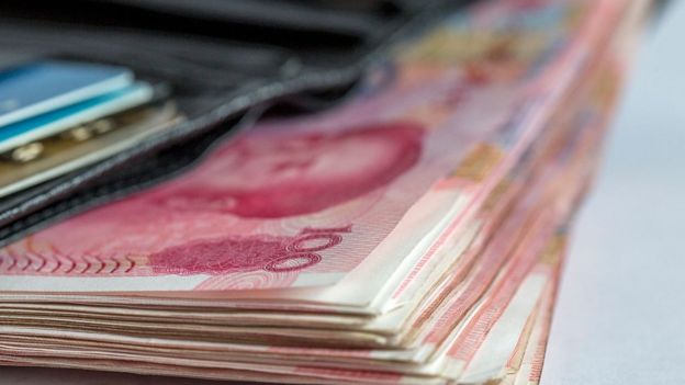 Wallet full of Chinese money bills