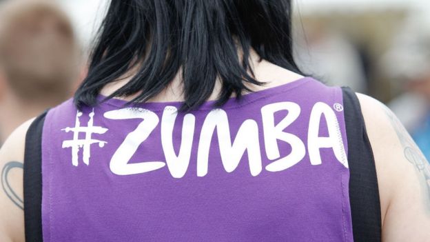 Una mujer lleva una camiseta con el nombre Zumba.