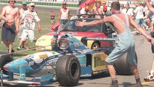 Michael Schumacher celebrates winning the 1995 German Grand Prix for Benetton-Renault at Hockenheim