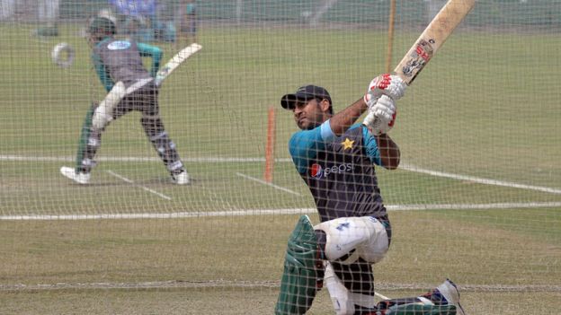 Pakistani cricket captain Sarfraz Ahmad (R) hits a shot during a practice session at the Gaddafi Cricket Stadium in Lahore on 8 September 2017, for the forthcoming World XI tour to Pakistan